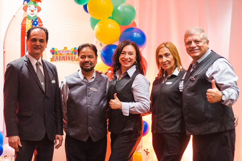 Five Hyatt team members posing at a balloon photo booth