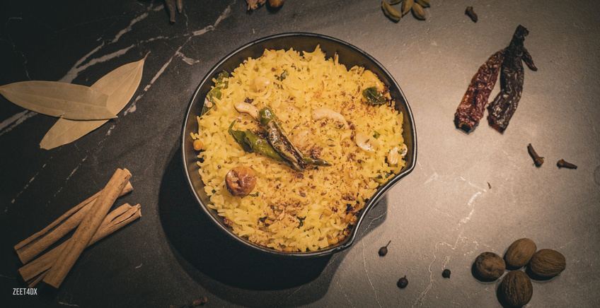 Bowl of biryani with chilies from above