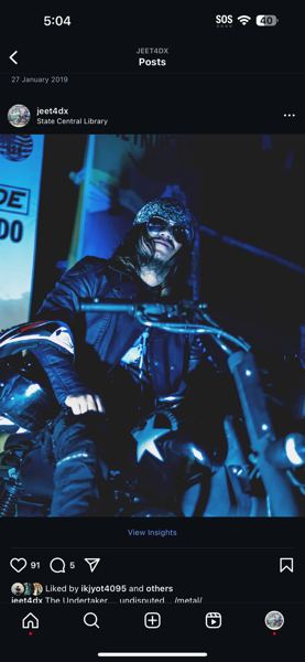 Instagram post of a costumed figure in blue light