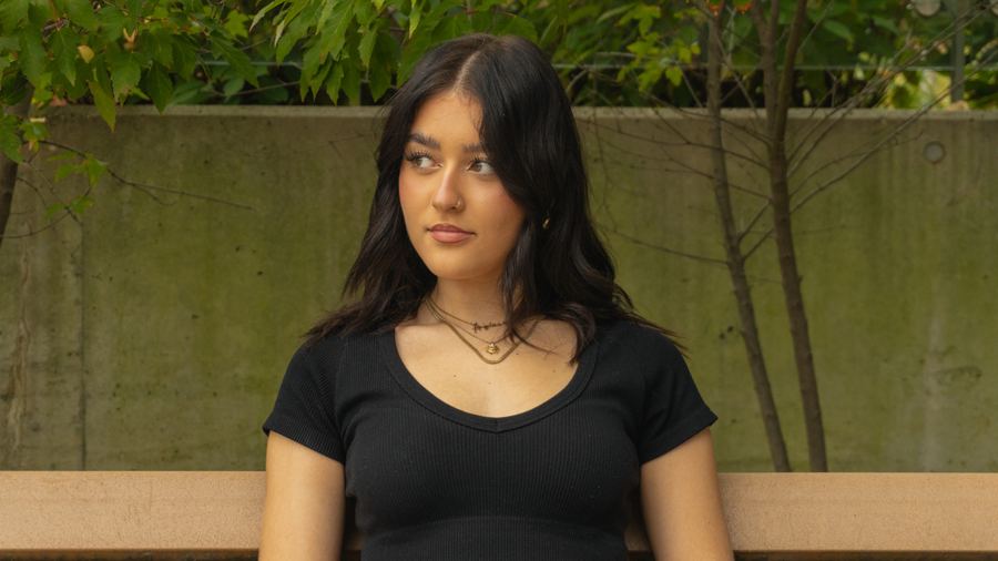 Portrait of a young woman on a park bench